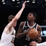 Mar 31, 2024; Brooklyn, New York, USA; Brooklyn Nets forward Dorian Finney-Smith (28) looks to the basket against Los Angeles Lakers guard Austin Reaves (15) during the first quarter at Barclays Center. Mandatory Credit: Vincent Carchietta-USA TODAY Sports